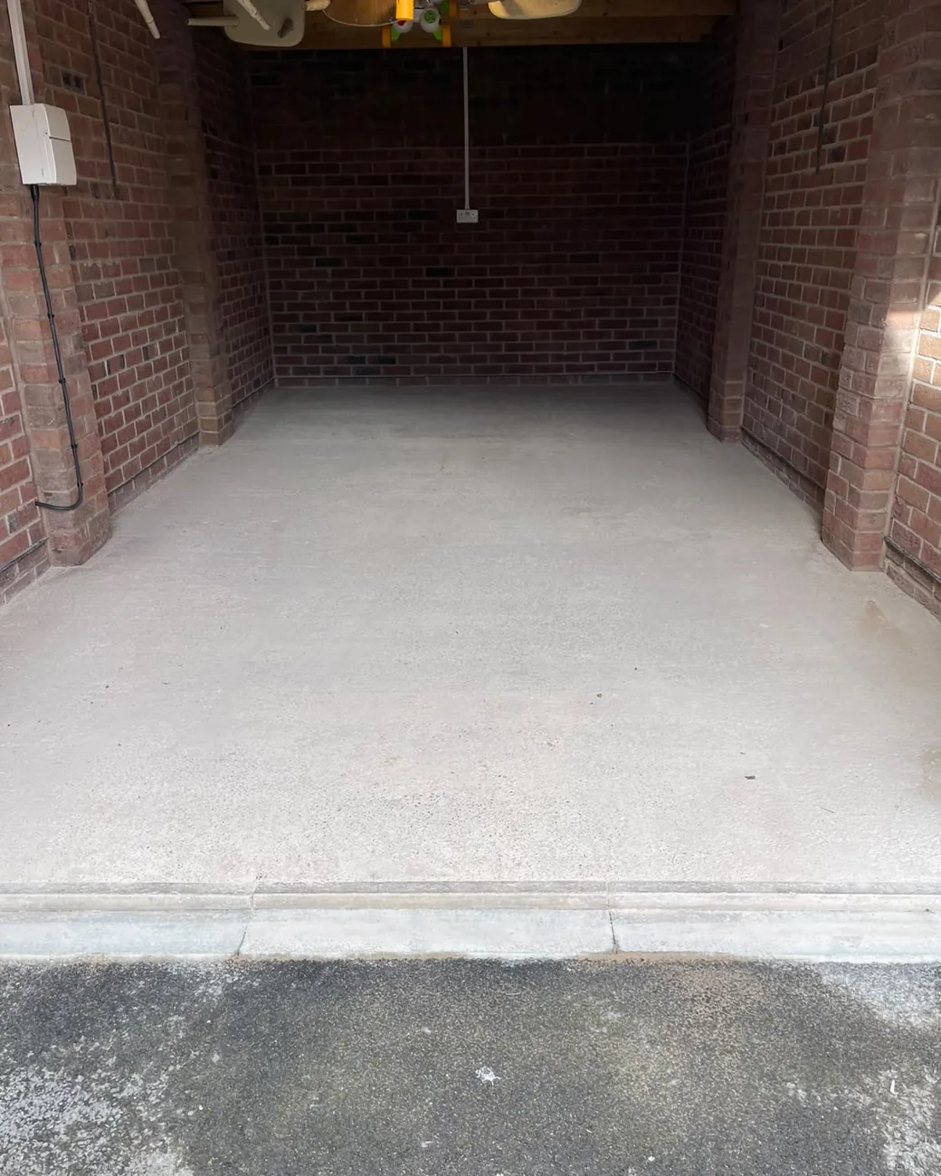 Bare concrete garage floor before coating