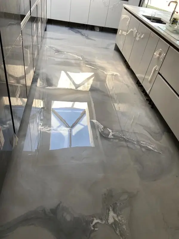 Silver metallic epoxy resin kitchen floor with a mirror gloss finish