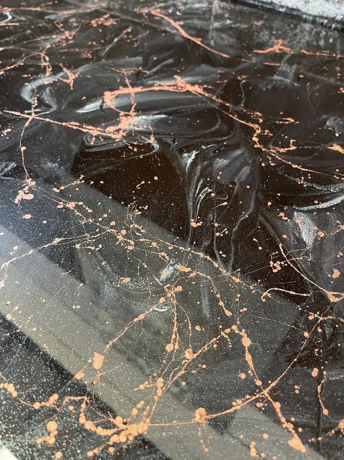 Black and copper metallic epoxy resin floor with a mirror gloss finish